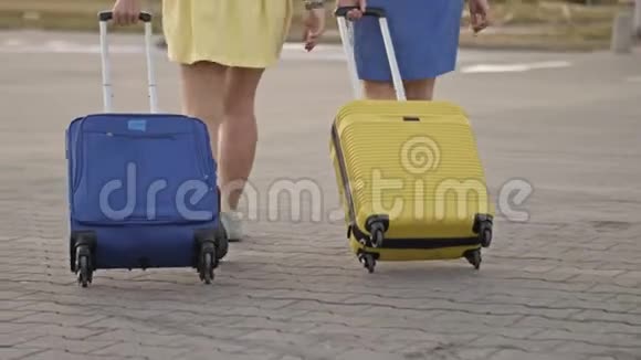 旅客携带行李箱在火车站站台行走两个拿着行李的女人去机场视频的预览图