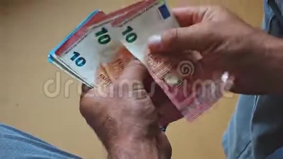 白种人男性手数欧元钞票从后面近距离观看视频的预览图