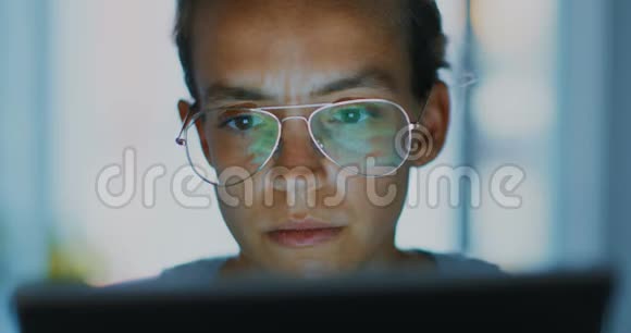 高质量的4k12位镜头年轻的办公室工作人员在笔记本电脑上打眼镜找出问题深夜视频的预览图
