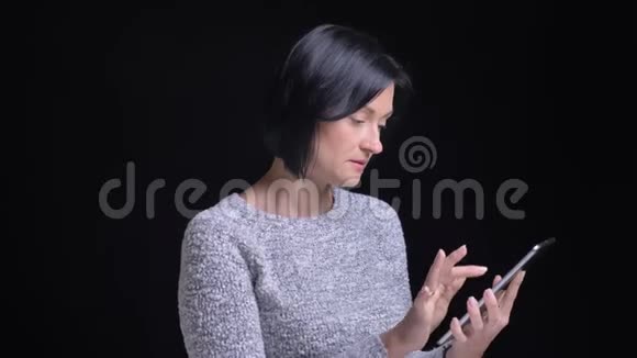 用平板电脑为成年快乐美丽的白种人女性特写肖像自信地显示绿色屏幕视频的预览图