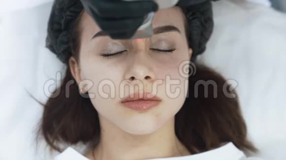 激光面部剥离手术中年轻女性的俯视图慢动作视频的预览图