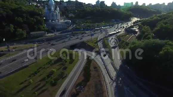 汽车驶过城市的教堂高速公路交汇处的空中观景车交通视频的预览图