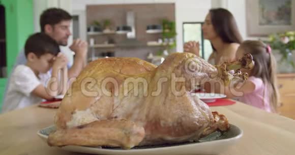 一家人一起祈祷然后在家里的餐桌上吃午饭视频的预览图