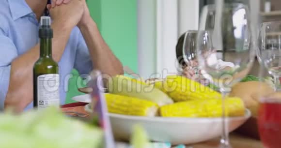家庭在家中的餐桌上吃午饭前祈祷视频的预览图