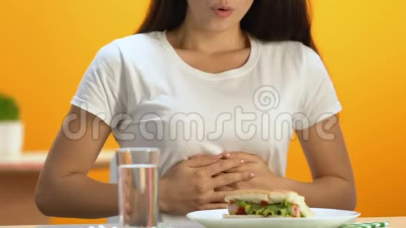 吃了快餐午餐后呼吸困难的女人吃了消化药丸视频的预览图