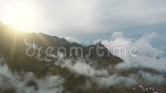 在加那利群岛的特内里费日出时飞越美丽的山和云水滴落下来视频的预览图