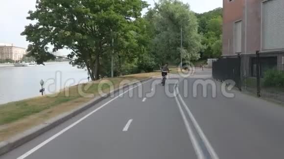 一个女孩在公园里骑自行车一大早视频的预览图