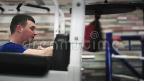 一个男子拳击沙包第一次在健身房带着坚定的面容表情视频的预览图