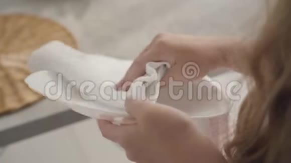 特写少女白种人女性用柔软的白布擦拭盘子勤劳的女孩做家务视频的预览图