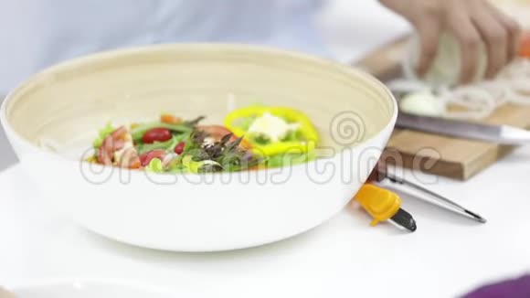 亚洲女人准备蔬菜做沙拉当午餐视频的预览图