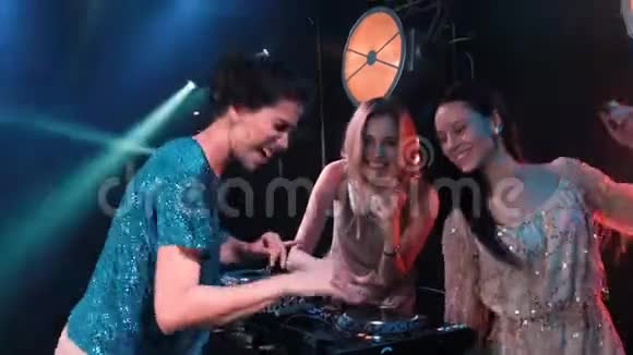 三个微笑的年轻女孩乐队在转盘上播放音乐和唱歌有唱碟机和金发歌手视频的预览图