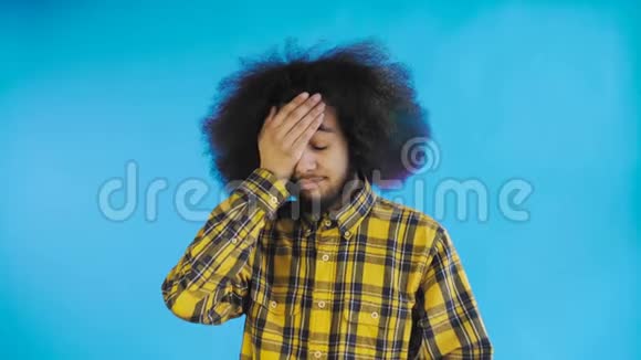 失望的美国黑人男性在蓝色背景下做面部手势情感概念视频的预览图
