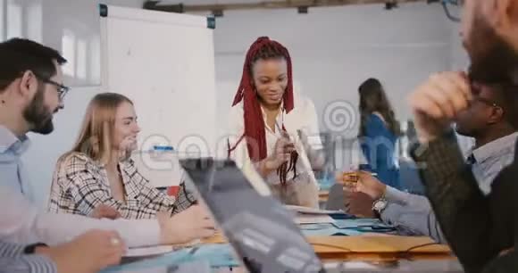 快乐职业黑人发展公司经理女士在现代办公室向商业伙伴展示项目视频的预览图