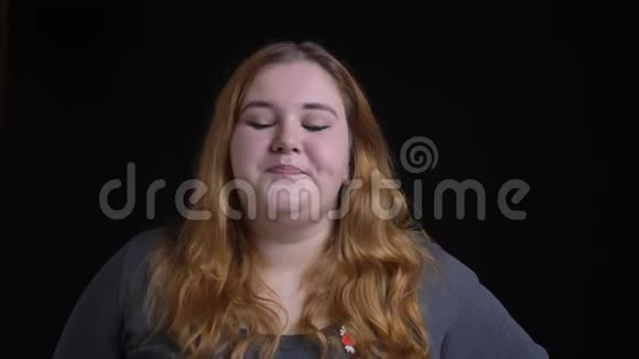 年轻超重的白种人女性尴尬的特写镜头用一只手在面前拍着她的头视频的预览图