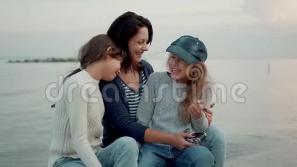 孩子们笑拥抱亲吻他们的母亲家庭肖像户外视频的预览图
