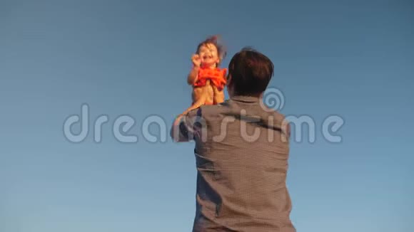 父亲把女儿扔到蓝天上爸爸和一个小孩子在他的怀里对抗天空幸福的家庭在玩耍视频的预览图