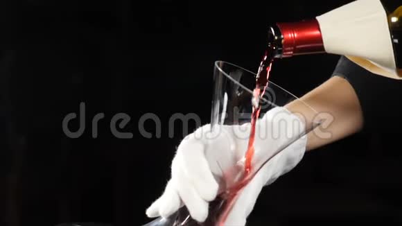 酒庄的概念红酒倒在深色背景下的酒壶里将红色酒瓶的颈部倒入视频的预览图
