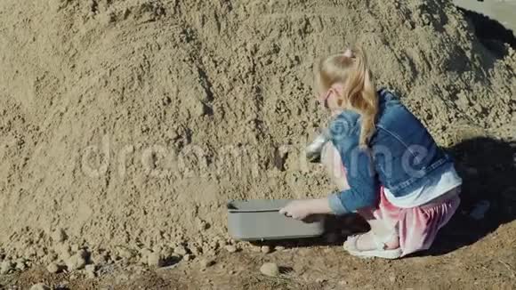 女孩把沙子倒进花盆里业余园艺视频的预览图
