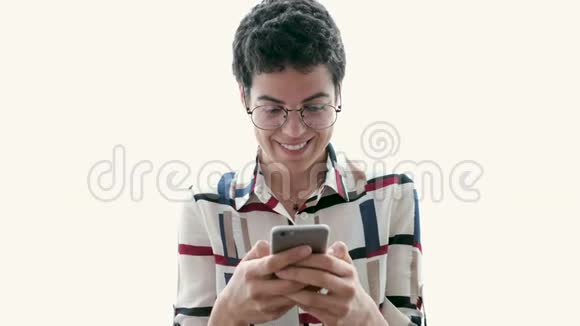 微笑的年轻商务女性使用她的手机而站在白色的背景视频的预览图