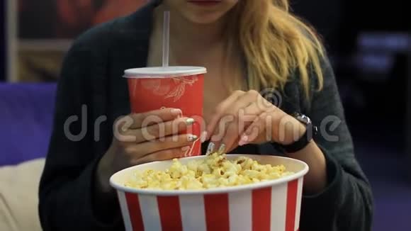 吃爆米花喝饮料的女孩视频的预览图