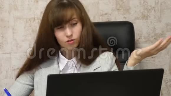 年轻的女商人在笔记本电脑上工作美丽的商务女性正在笔记本电脑上进行视频会议A视频的预览图