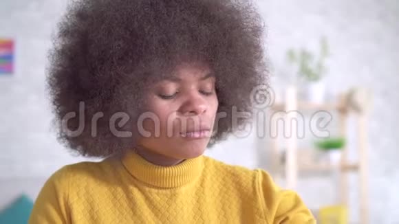 美丽的非洲裔美国妇女有非洲发型吃一片药丸喝一杯水视频的预览图