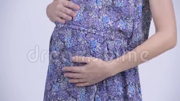 微笑着的美丽的亚洲孕妇的倾斜镜头视频的预览图