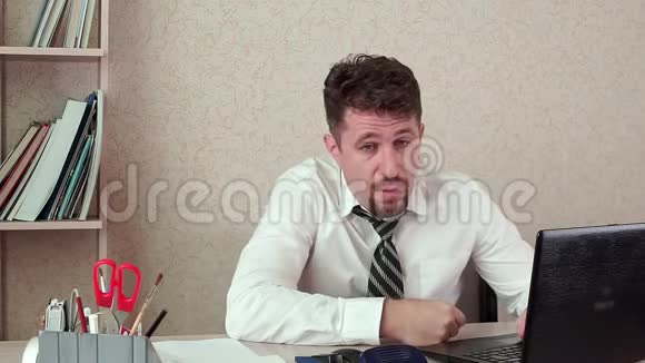 办公室经理累人在笔记本电脑上工作他热他的领带掐死他了视频的预览图