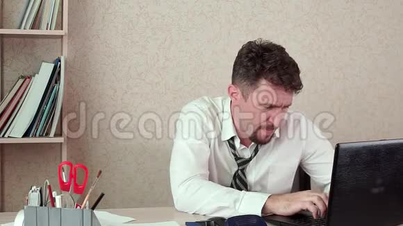 办公室经理累人在笔记本电脑上工作他调整领带视频的预览图