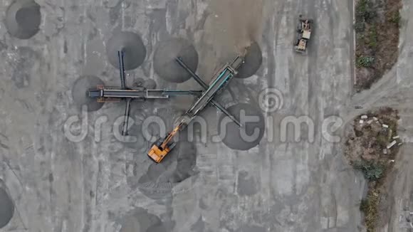 在施工现场的AERIALSHOT移动迷你敷料区碎石机将碎石粉碎成碎石的过程视频的预览图