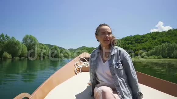 年轻女子坐在摩托艇上享受着乘坐的乐趣视频的预览图