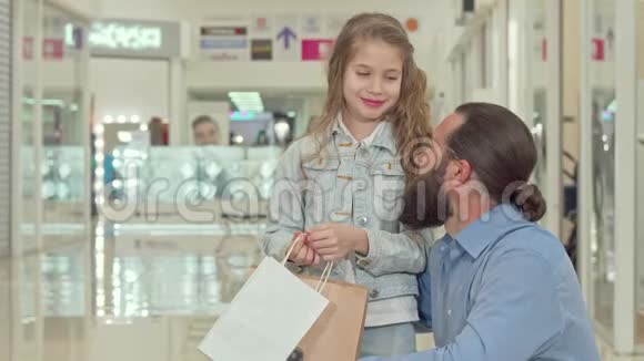 小女孩指了指在购物中心向她父亲展示了一些东西视频的预览图