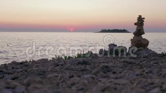 帆船在石滩上对着海日落的天空视频的预览图