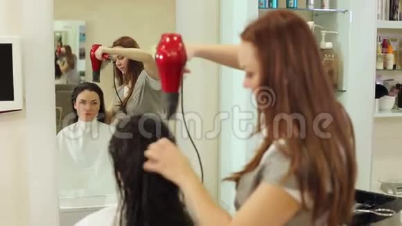 美容师在客厅理发后吹干女人的头发视频的预览图