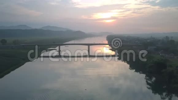 日落时分天桥从高高的长桥上穿过宽阔的河流视频的预览图