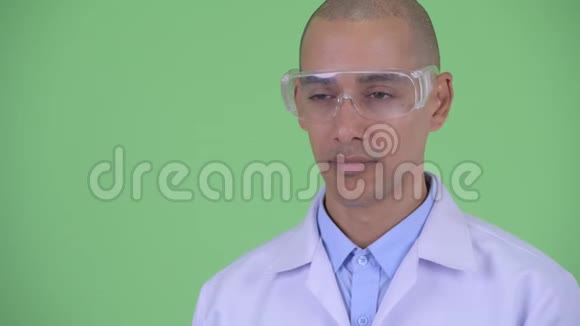 戴着防护眼镜的快乐秃顶多民族医生脸视频的预览图