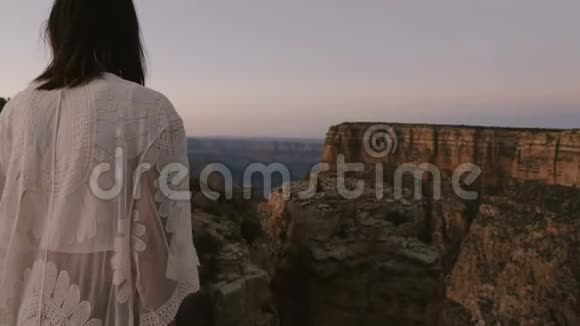 慢镜头移步身后快乐年轻女性游客观看史诗般的日落大峡谷山保护区风光视频的预览图