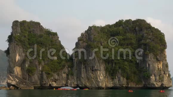 游客乘坐皮艇或独木舟探索越南猫巴国家公园下龙湾视频的预览图