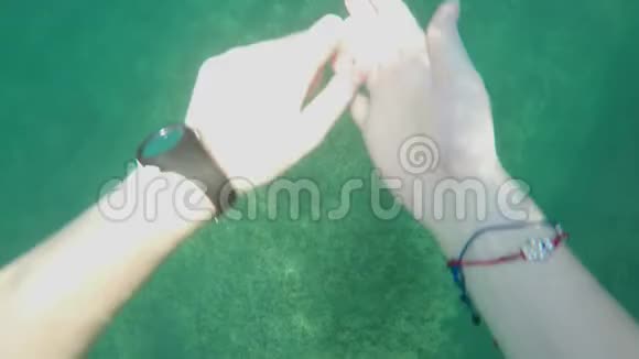 白种人女孩的POV在藻类生长的石头上潜入超氨酸海水穿蓝色泳裤的男人视频的预览图