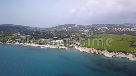 塞浦路斯海岸线的州长海滩鸟瞰令人惊叹的蓝色海水明亮的绿草视频的预览图