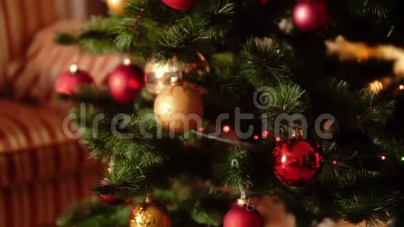 4k摄像机在客厅的圣诞树上慢慢移动并在五颜六色的发光灯和黄灯上翻腾视频的预览图