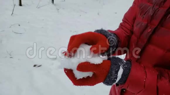 制作雪球并展示给照相机冬季游戏娱乐的人视频的预览图