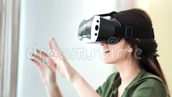 令人惊讶的欧洲年轻女子戴着虚拟现实面具眼镜双手翻页视频的预览图