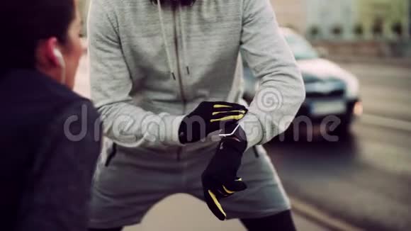 一对合适的跑步者在城市街道上测量户外时间视频的预览图