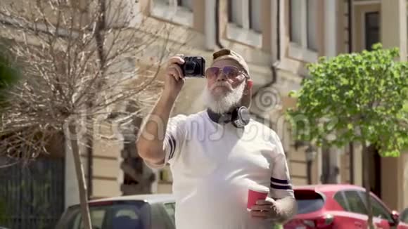 时尚高级男士举杯咖啡在夏季城市拍照的肖像视频的预览图