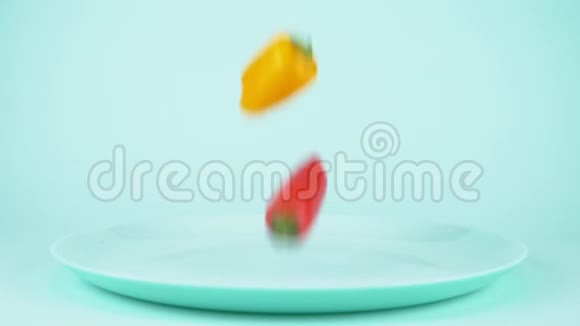 蓝色背景的蓝色盘子上落着五颜六色的小甜椒视频的预览图