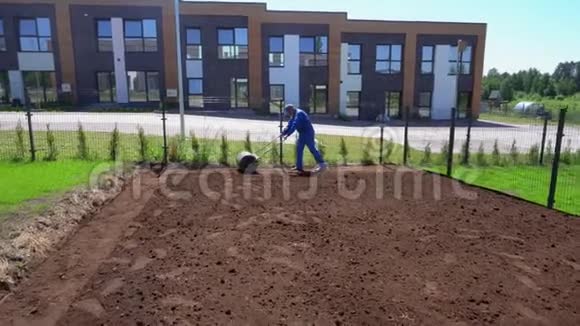 专业工人拉草坪辊用于平整庭院土壤万向节运动视频的预览图