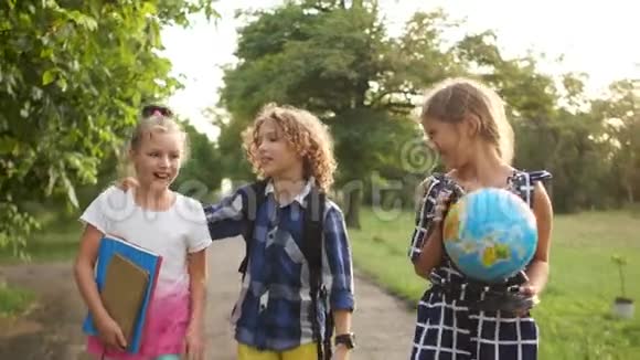 快乐的孩子从学校回来同学们举着一个大地球日落时分视频的预览图