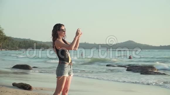 幸福的女人在海上拍日落视频的预览图