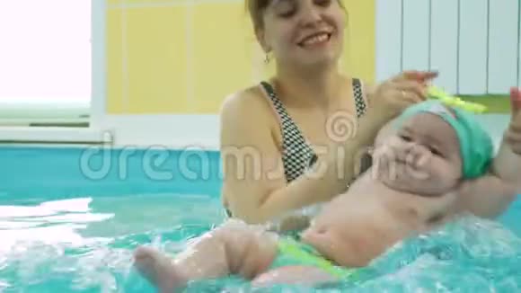 女婴与教师一起做水上运动视频的预览图